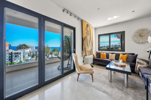 Living area with sea views and balcony access