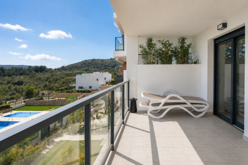 Covered balcony with comfortable seating area