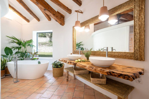 Modern bathroom with bathtub and Mallorcan charm