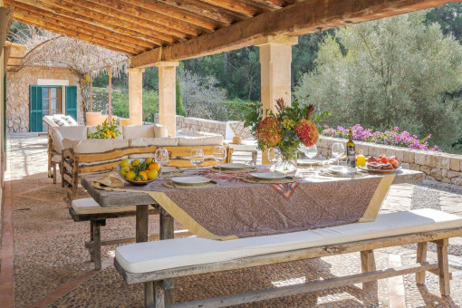 Covered terrace with dining table and Mediterranean atmosphere