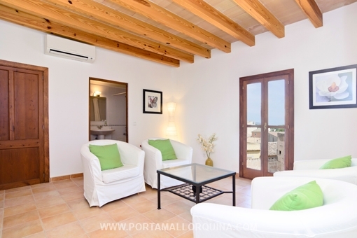 Bright living area with wooden ceiling beams