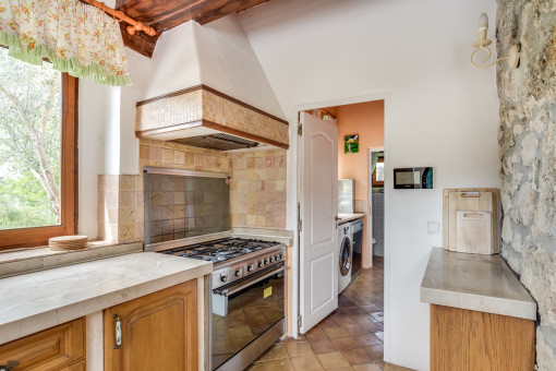 The kitchen offers a separate storage and washing room