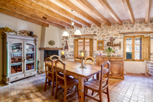 Authentic dining area with fireplace and stone wall