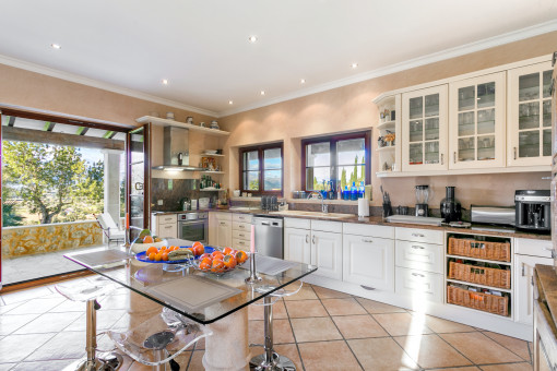 Large kitchen with further dining area