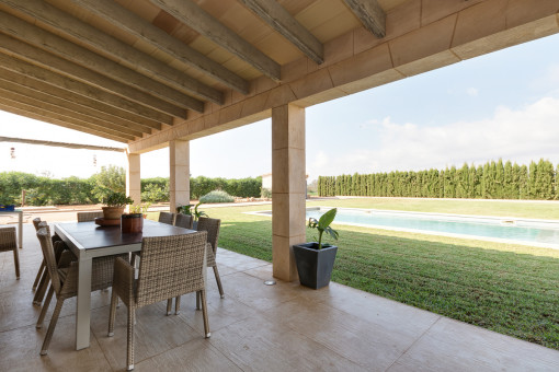 Covered terrace with pool view