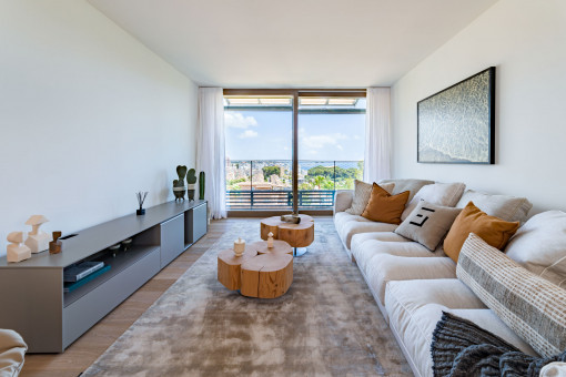 Light flooded living area with balcony and sea views