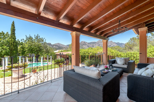 Covered lounge terrace with garden views