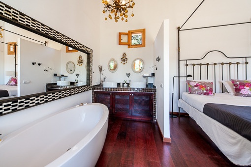 Bright bathroom with bathtub and bedroom acces