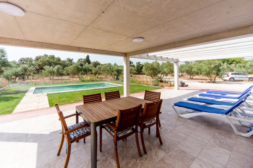 Covered terrace with dining area and views of the garden