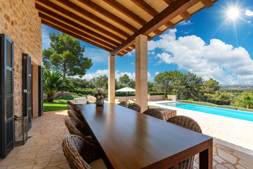 Dining terrace with pool view