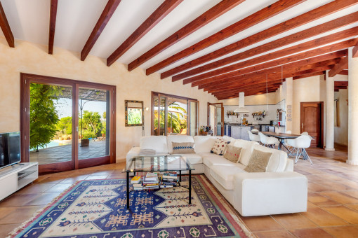 Open living area with wooden ceiling beams