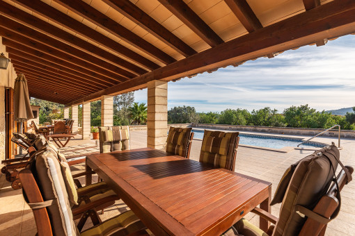 Covered terrace with pool views