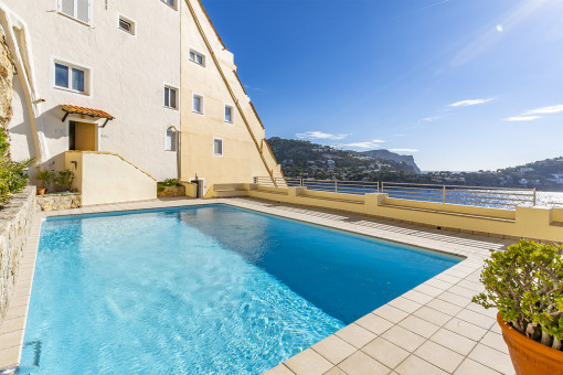 Community pool is surrounded by a terrace