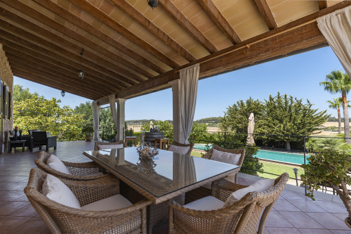 Covered terrace with pool views