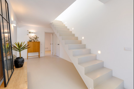 Bright entrance area with elegant staircase