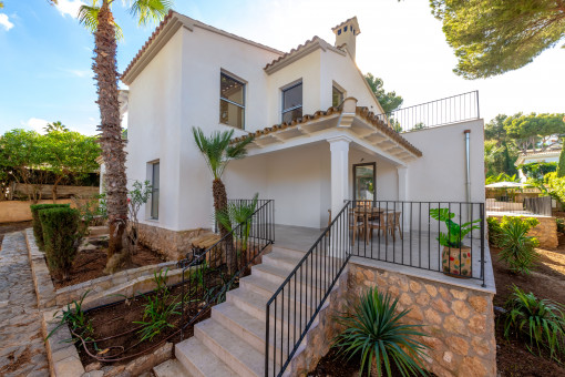 Rear view of the house with covered terrace and garden access