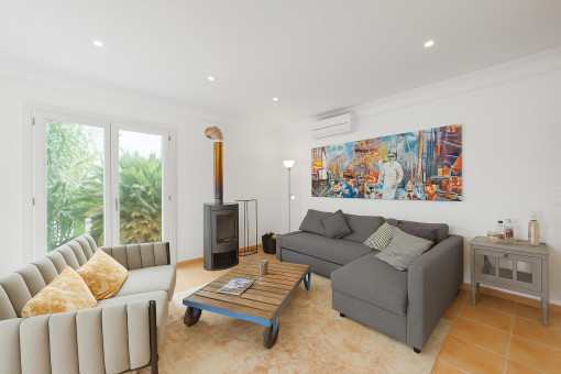 Stylish living room with wood-burning stove and air conditioning