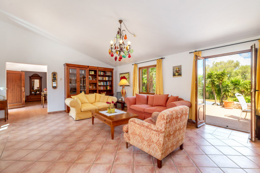 Living area with fireplace and access to the patio and pool terrace