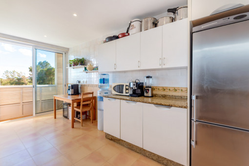 Bright separate kitchen with dining area