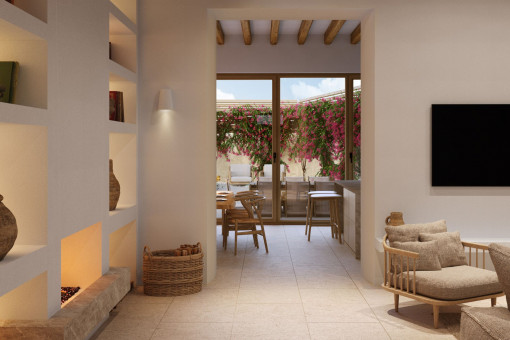 Cosy living room with fireplace and view of the Mediterranean courtyard