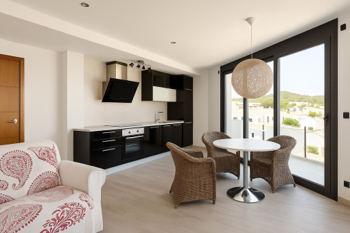 Kitchen with dining area and balcony