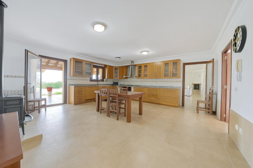 High-quality country-style kitchen with solid wood fronts and modern equipment.