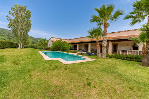 Spacious garden with pool and palm trees