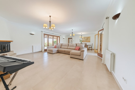 Spacious living area with fireplace and access to two terraces