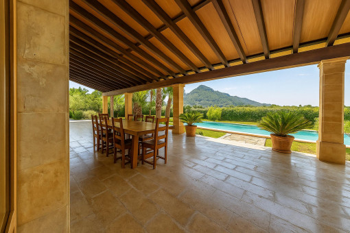 Covered terrace with spacious dining area and mountain views