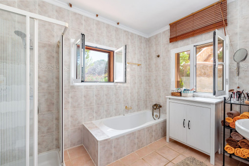 Bathroom with window, bathtub and shower