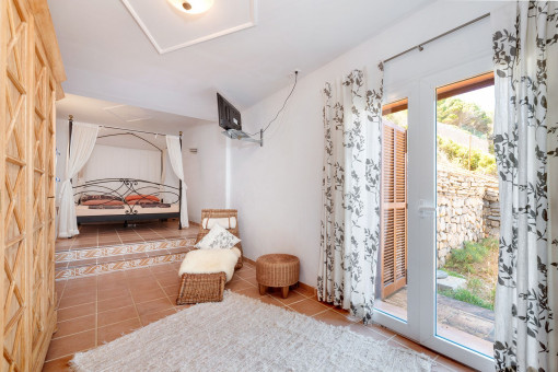 Charming main bedroom with access to the outdoor space and plenty of light