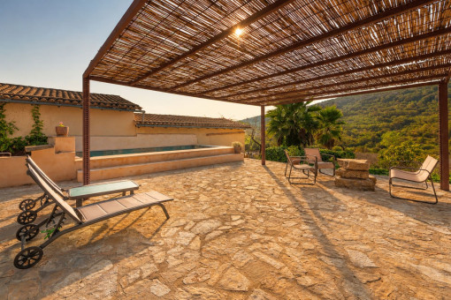 Pergola terrace with pool views and Mediterranean landscape
