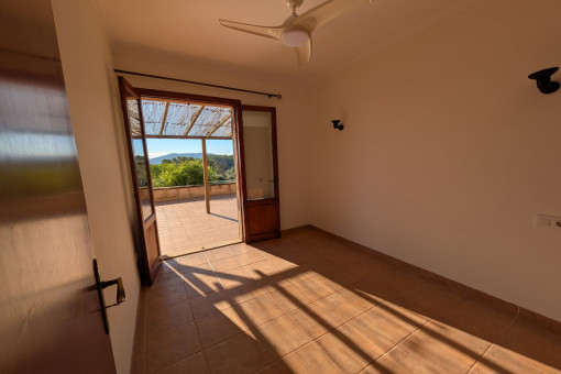 Bright bedroom with access to the terrace and views of the countryside