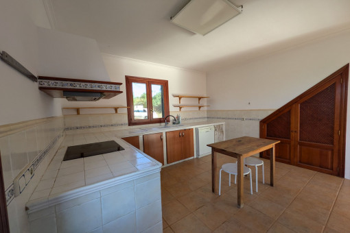Generous kitchen with wooden fronts, electrical appliances and access to the garden