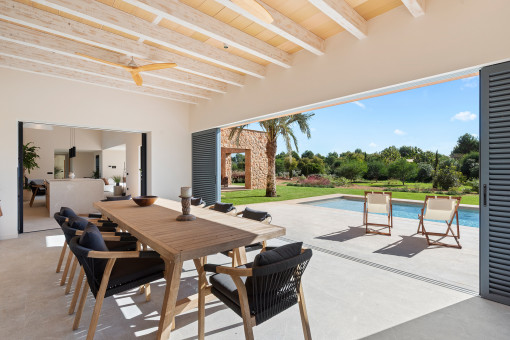 Indoor-outdoor dining with views of lush Mediterranean landscaping