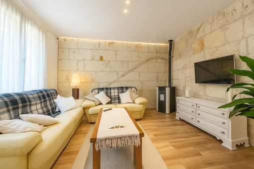 Living area with natural stone wall and pellet stove