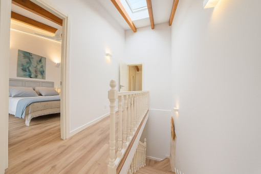 Upstairs hallway with skylight and exposed beams