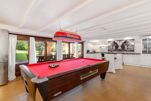 Living area with open kitchen on the lower level with billiard table