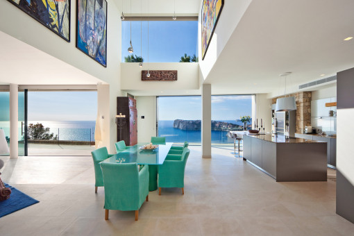 Open kitchen and dining area with high ceilings and impressive sea views