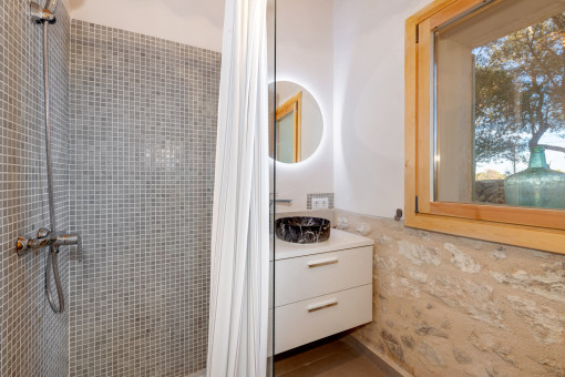 Bathroom with modern shower and stylish natural stone