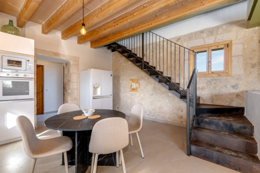 Dining area with natural stone wall and open-plan layout