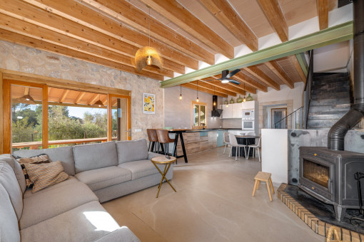 Living area with wood-burning stove and natural stone accents