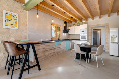 Spacious kitchen with dining area and wooden beam ceiling