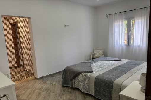 Bedroom with double bed, dressing area and en-suite bathroom