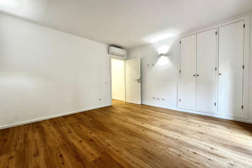 Bedroom with built in wardrobe and terrace access