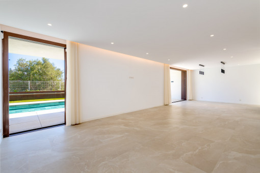 Bright living area with access to the pool and terrace