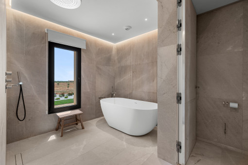 Master bathroom with natural stone finishes and bathtub