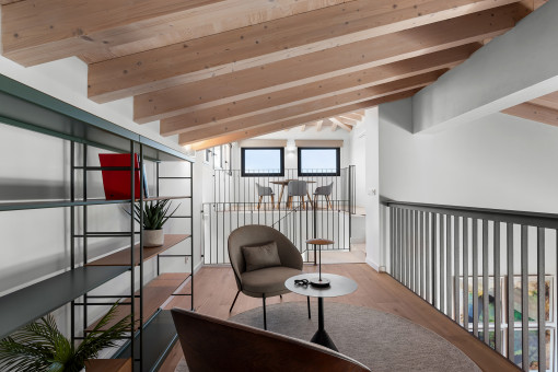 Elegant gallery space with reading chair and built-in shelving