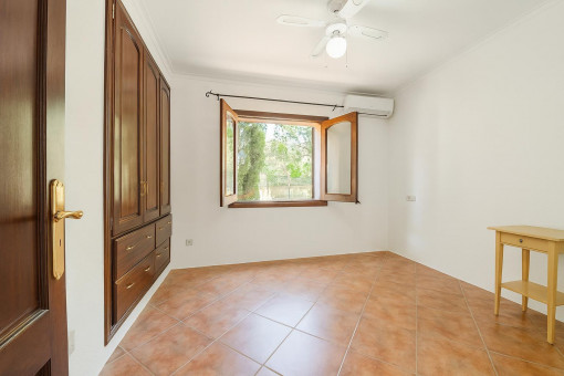 Empty room with wooden closet and window