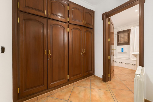 Hallway with wooden wardrobe and bathroom view